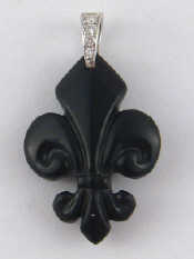 Appraisal: A carved onyx Fleur de Lys pendant with white metal