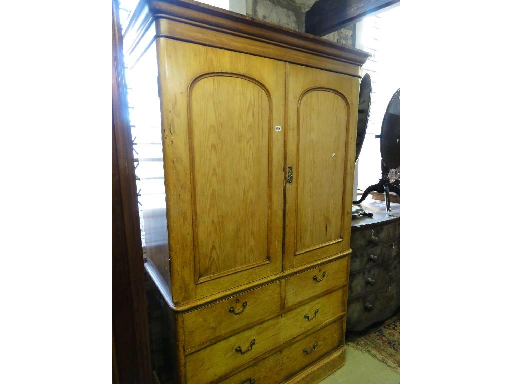 Appraisal: A Victorian stripped pine linen press the upper section enclosed