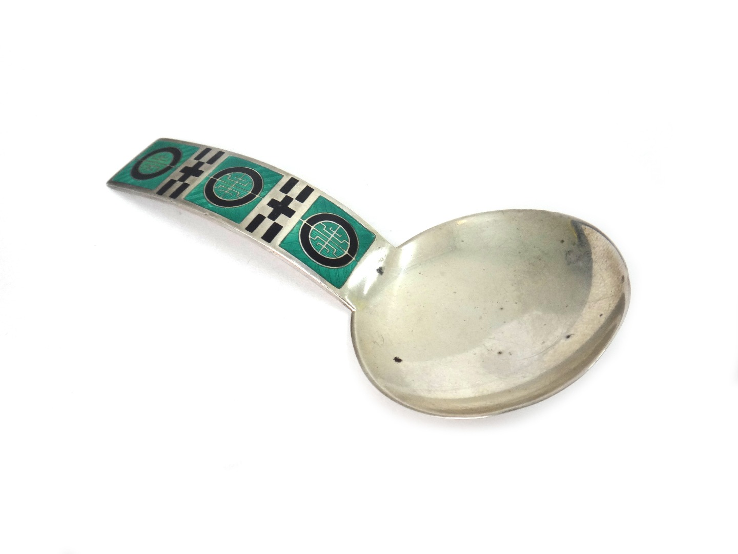 Appraisal: A Norwegian silver and enamelled caddy spoon Marius Hammer with