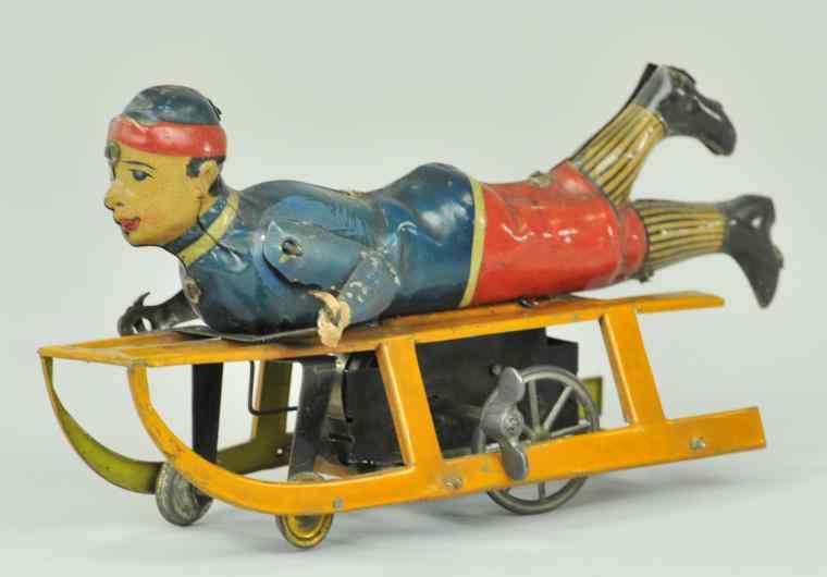 Appraisal: BOY ON SLED TOY Germany Hess lithographed tin clockwork housed