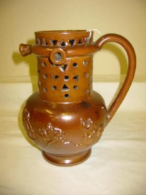 Appraisal: A SALT GLAZE PUZZLE JUG of baluster form with pierced