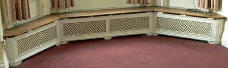 Appraisal: Four pierced cast radiator surrounds with wooden tops on bracket