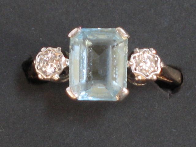 Appraisal: A DIAMOND-SET DRESS RING the central blue step-cut stone claw-set