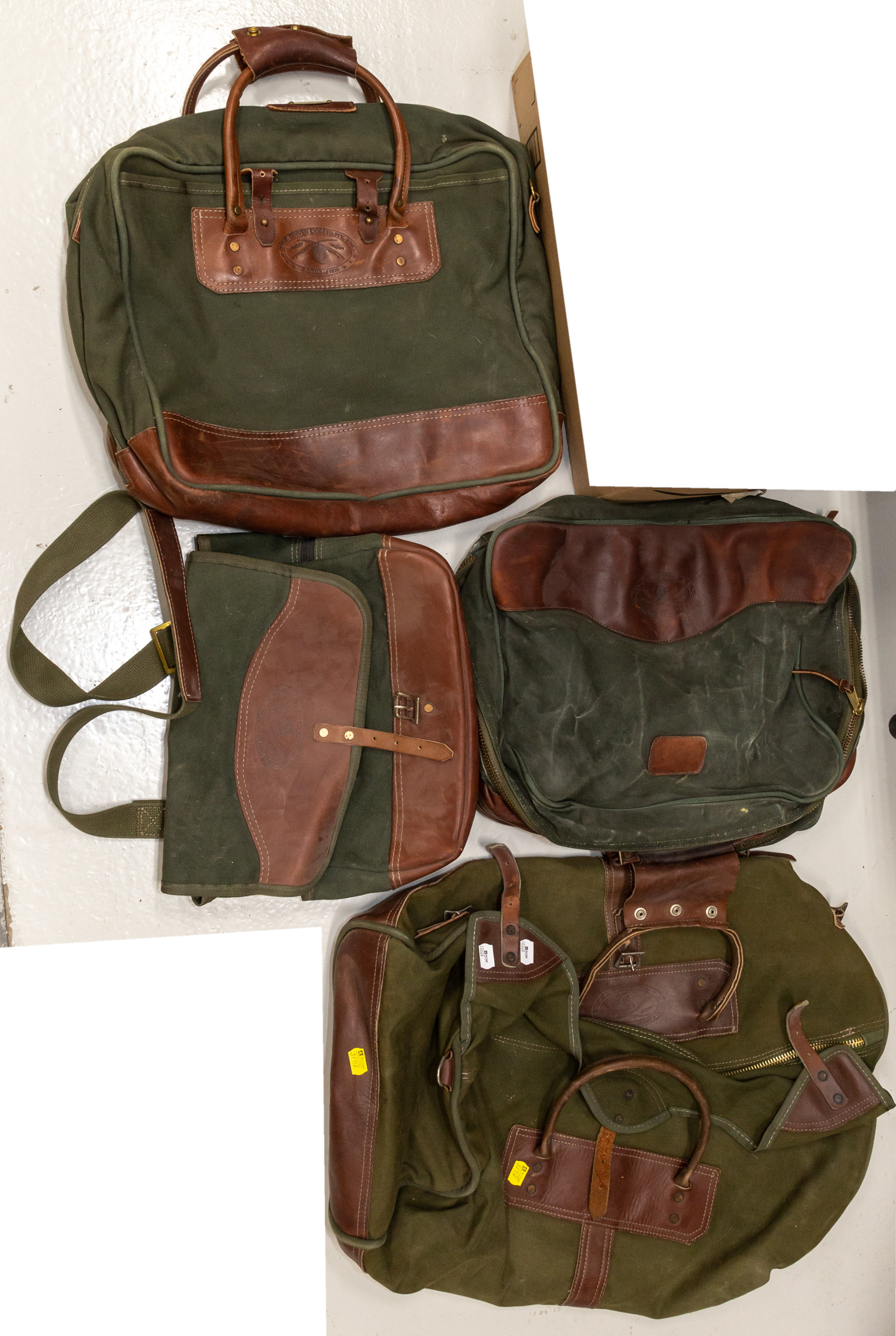 Appraisal: FOUR PIECES OF ORVIS LUGGAGE Leather and heavy green canvas