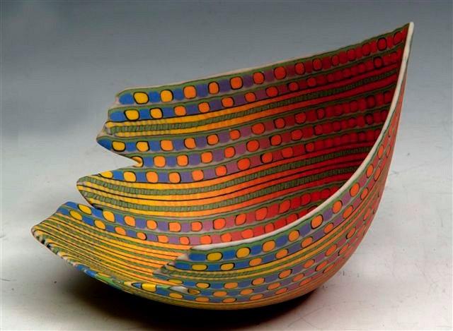 Appraisal: A DOROTHY FEIBLEMAN MULTI-COLOURED ASYMMETRICAL LAMINATED BOWL with jagged edge