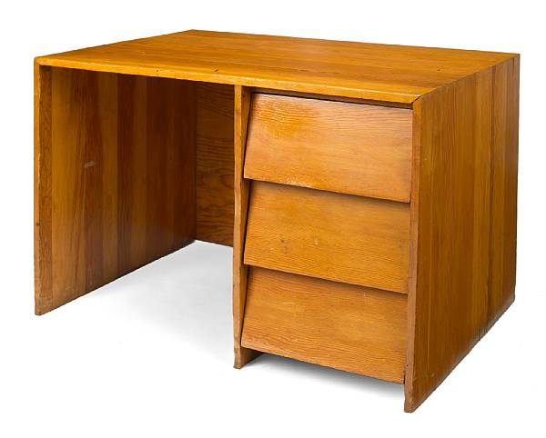 Appraisal: A stained pine kneehole desk designed by Frank Lloyd Wright