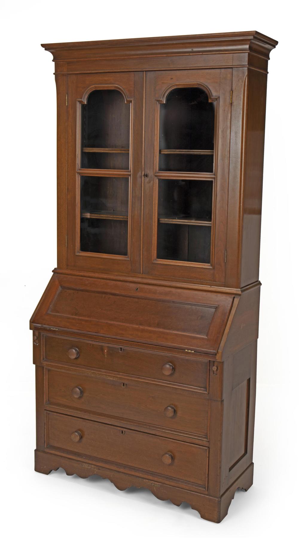 Appraisal: A walnut drop front secretary bookcase Fourth-quarter th Century The