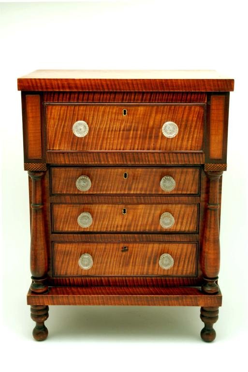 Appraisal: Miniature chest of drawers Of typical pillar and scroll Empire