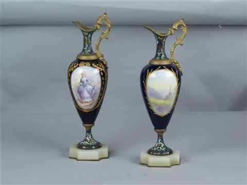 Appraisal: PAIR OF SEVRES STYLE PORCELAIN AND CHAMPLEVE EWERS signed Rochette