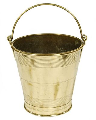 Appraisal: A brass bucket of tapering form with a swing handle