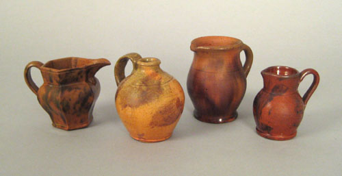 Appraisal: Three miniature redware pitchers and a jug th c h