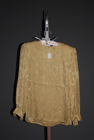 Appraisal: Andr Laug gold print pleated long sleeve silk blouse with