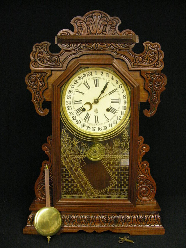 Appraisal: OAK WATERBURY GINGERBREAD KITCHEN CLOCK day clock SIZE h by