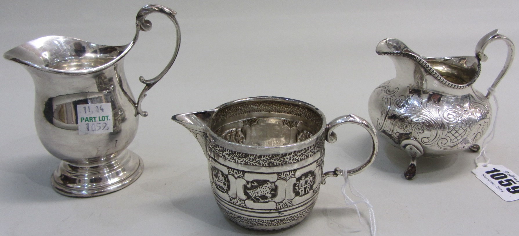 Appraisal: A Victorian silver milk jug with scroll engraved decoration within