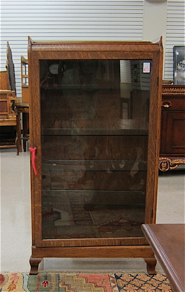 Appraisal: AN OAK DISPLAY CABINET American c having three rectangular adjustable