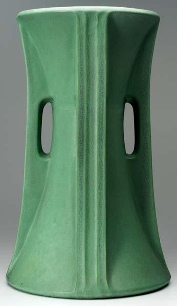 Appraisal: TECO Massive architechtonic corseted vase with four buttressed handles covered