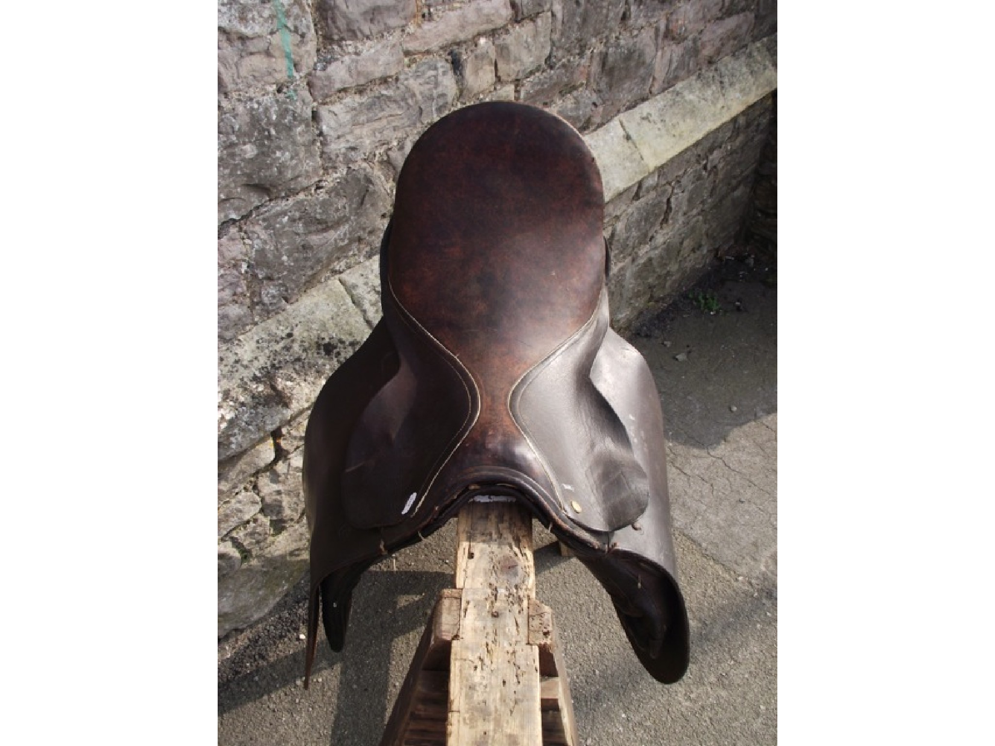 Appraisal: A dark brown leather equestrian saddle