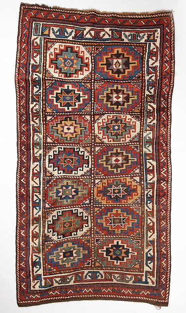 Appraisal: A KASAK POLYCHROME RUG with two rows of seven medallions