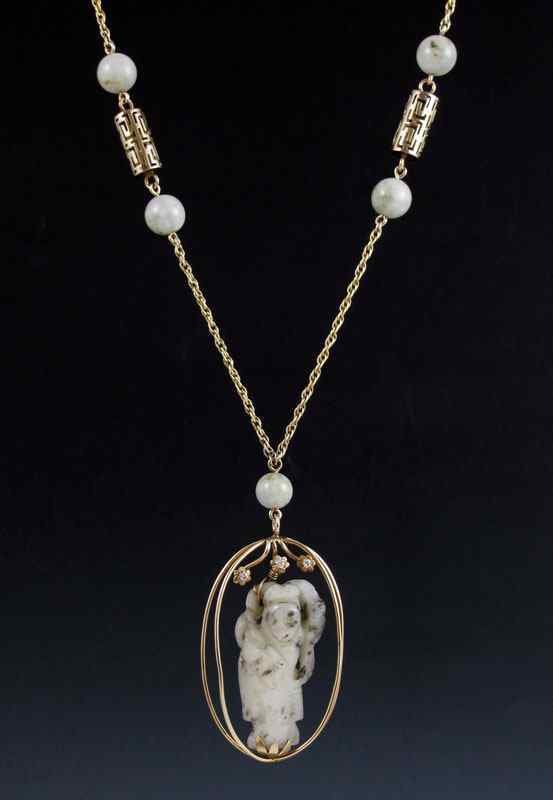 Appraisal: K GOLD AND CARVED JADE NECKLACE K yellow gold pendant