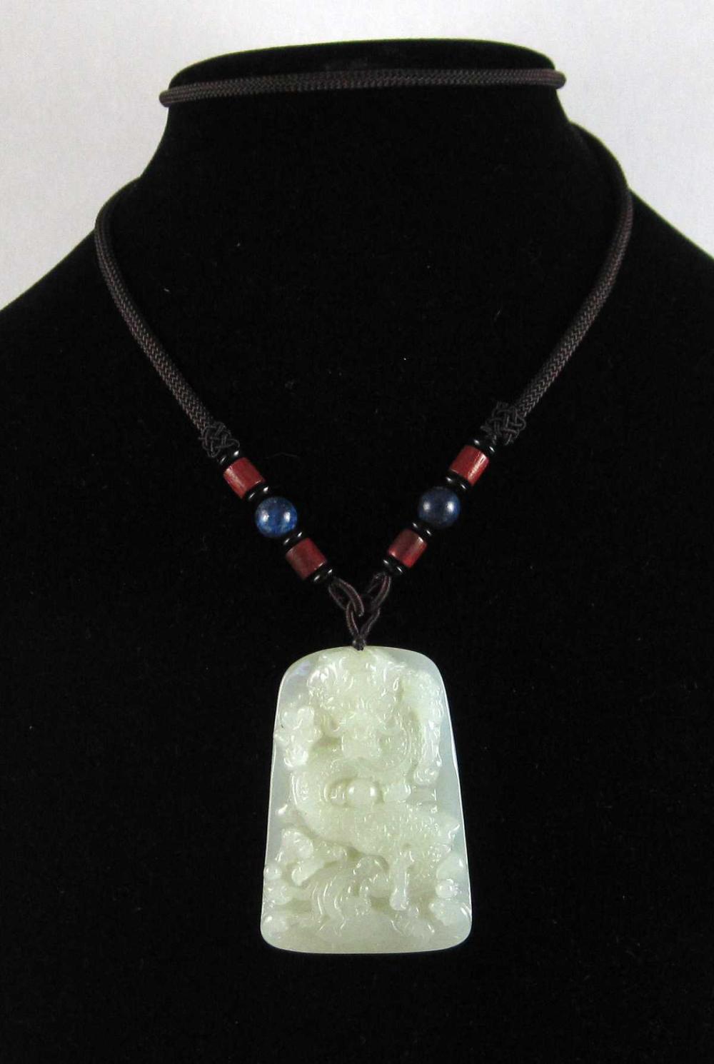 Appraisal: NEPHRITE JADE AND LAPIS LAZULI NECKLACE with a cord securing