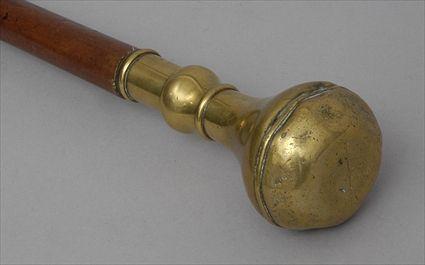 Appraisal: BRASS-HANDLED FRUITWOOD STAFF The balloon-shape handle above urn stem tapered