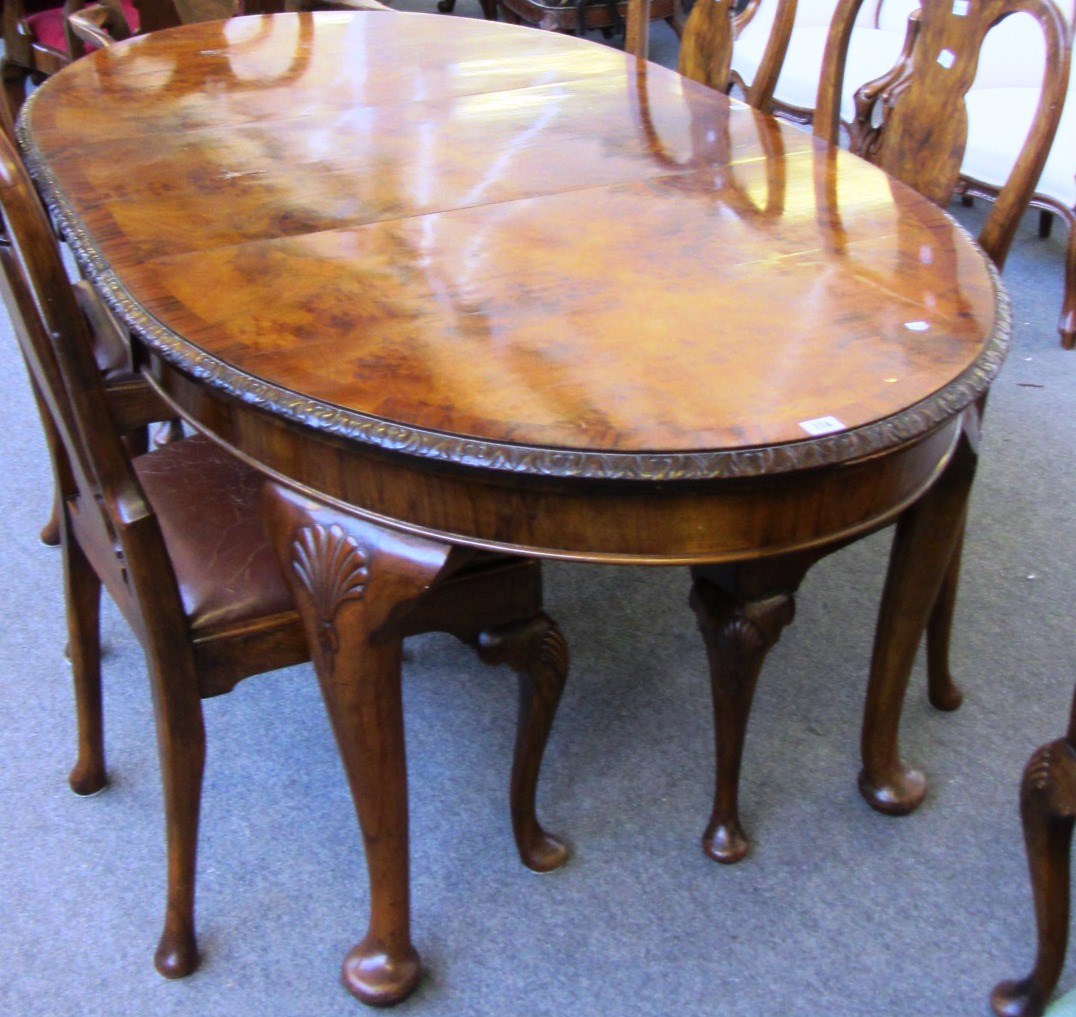 Appraisal: A th century figured walnut oval extending dining table of