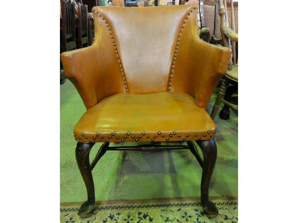 Appraisal: A Georgian style armchair with tan leather upholstery and decorative