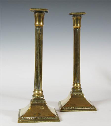 Appraisal: A group of brass candlesticks comprising a pair of fluted