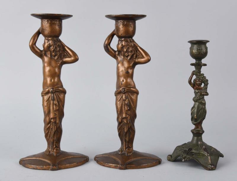 Appraisal: Cast Iron Grecian Statuettes Candlesticks One pair with original labels