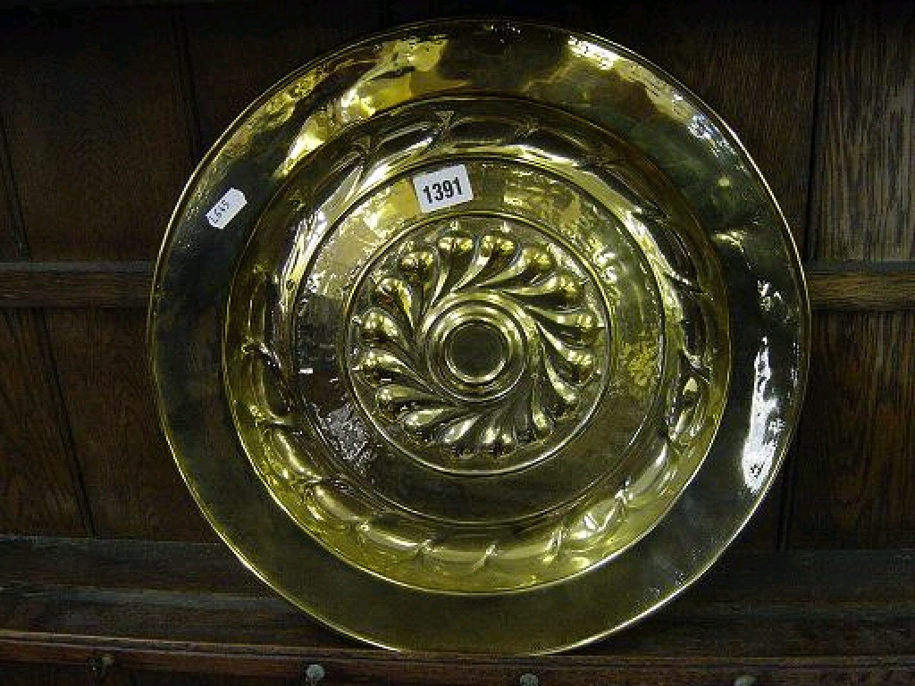 Appraisal: A th century polished brass alms dish of circular form