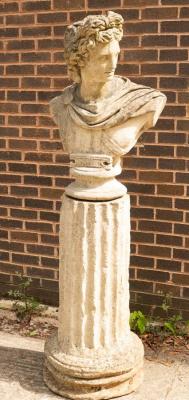 Appraisal: A composition stone bust of Apollo on a fluted plinth