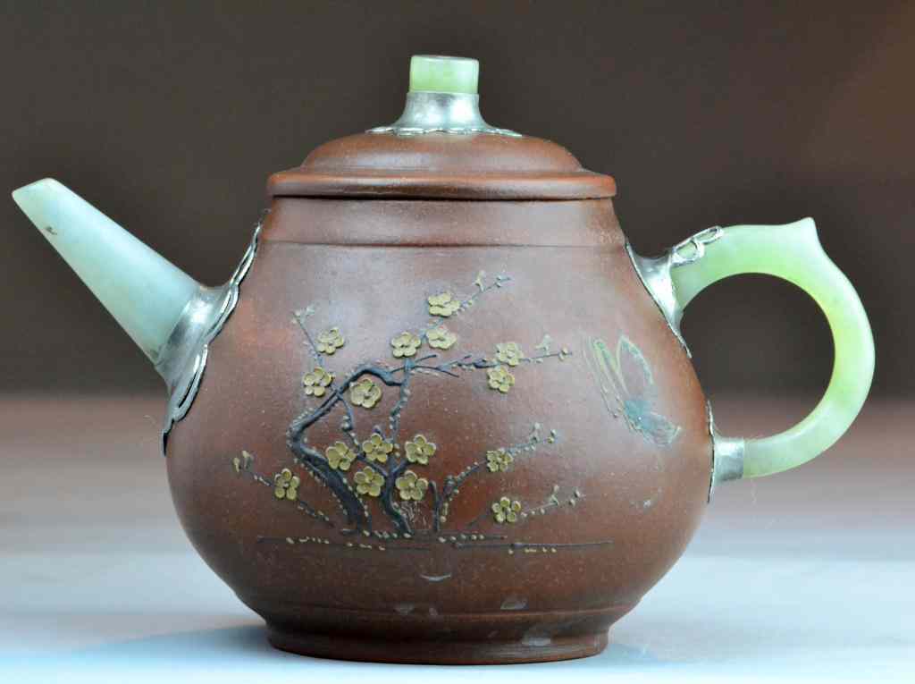 Appraisal: Chinese Yixing Pottery Jade Mounted Tea PotFinely molded to depict