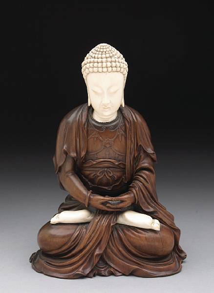 Appraisal: An ivory and carved wood seated Buddha th Century The