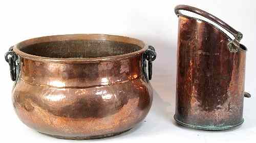 Appraisal: A circular copper cauldron with swing handles and a copper