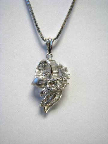 Appraisal: K white gold diamond pendant with solitaire and baguette diamonds