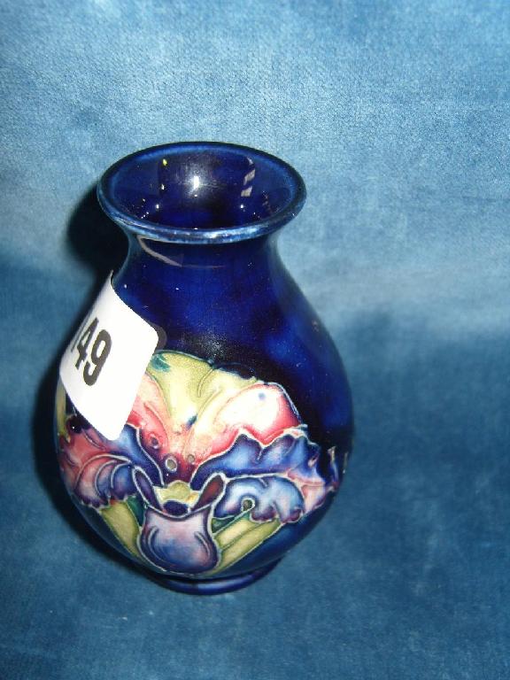 Appraisal: A small Moorcroft blue ground vase with orchid type decoration