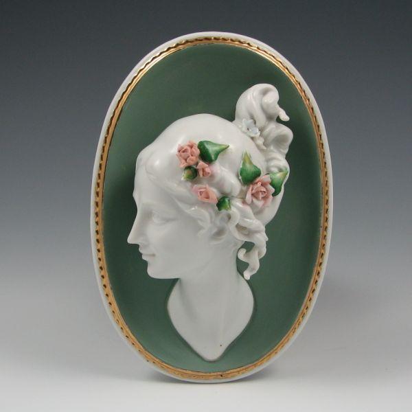 Appraisal: Porcelain wall plaque with woman with applied flowers in her