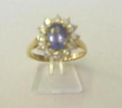 Appraisal: A TANZANITE AND DIAMOND CLUSTER RING the oval cut tanzanite