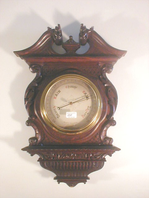 Appraisal: An Edwardian oak aneroid barometer by Negretti and Zambra -