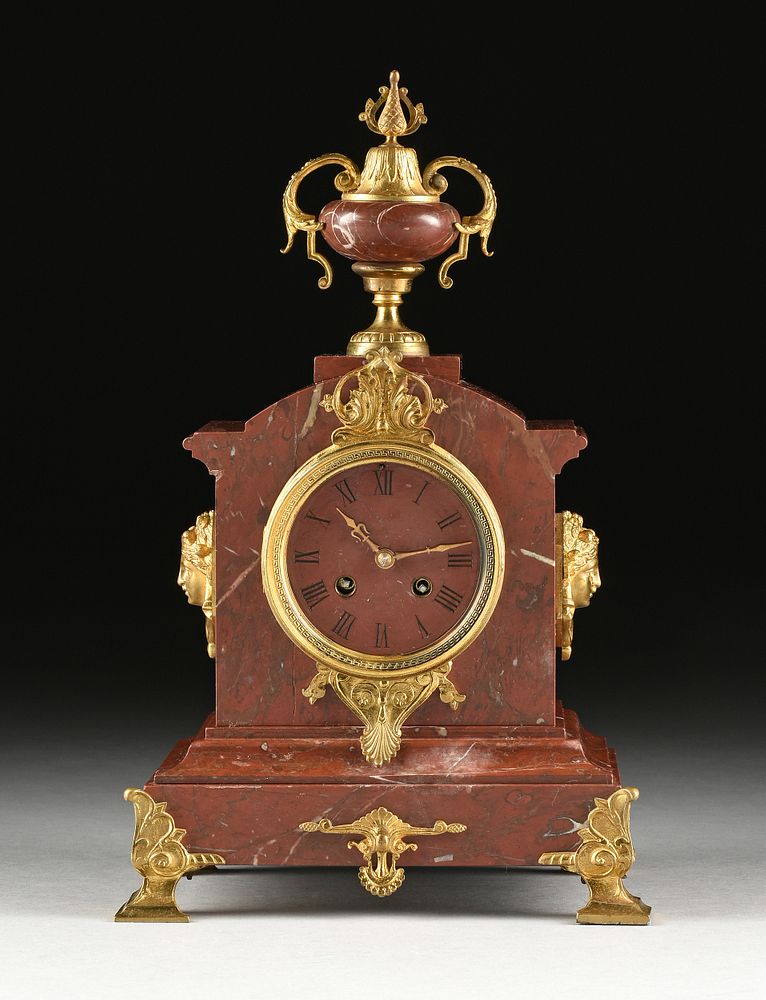 Appraisal: A FRENCH NEOCLASSICAL REVIVAL ORMOLU MOUNTED ROUGE GRIOTTE MARBLE CLOCK