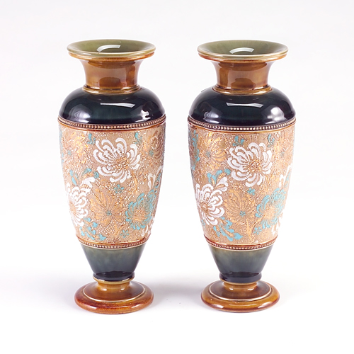 Appraisal: ROYAL DOULTON Pair of baluster vases decorated with panels of