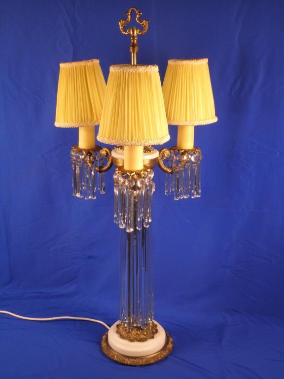 Appraisal: A gilt brass and white marble table lamp the three