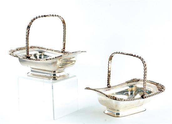 Appraisal: Pair silverplate cake baskets late th century pivoting handle on