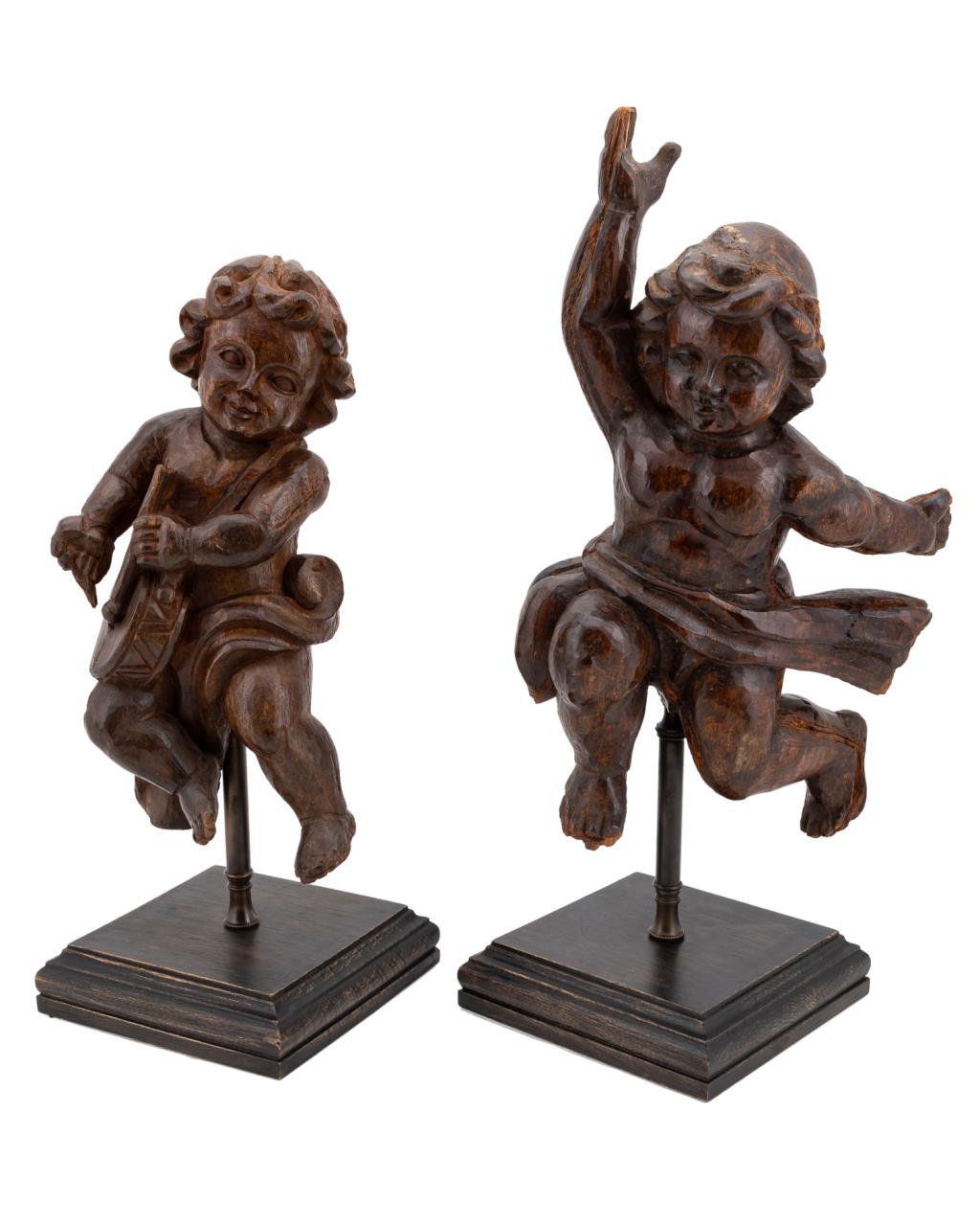 Appraisal: TWO CARVED WOODEN CHERUBS ON CONTEMPORARY BASES Group of two