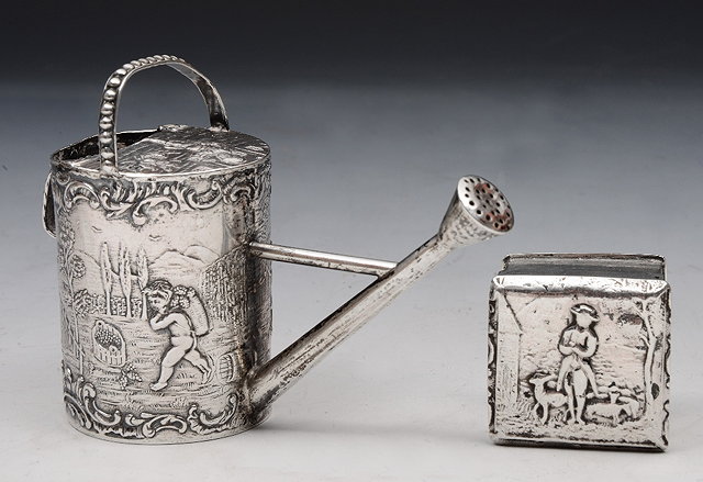 Appraisal: A CONTINENTAL SILVER MINIATURE WATERING CAN with chased rural scenes