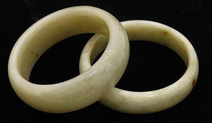 Appraisal: Two Pale-Green Stone Bangles and in diam interior