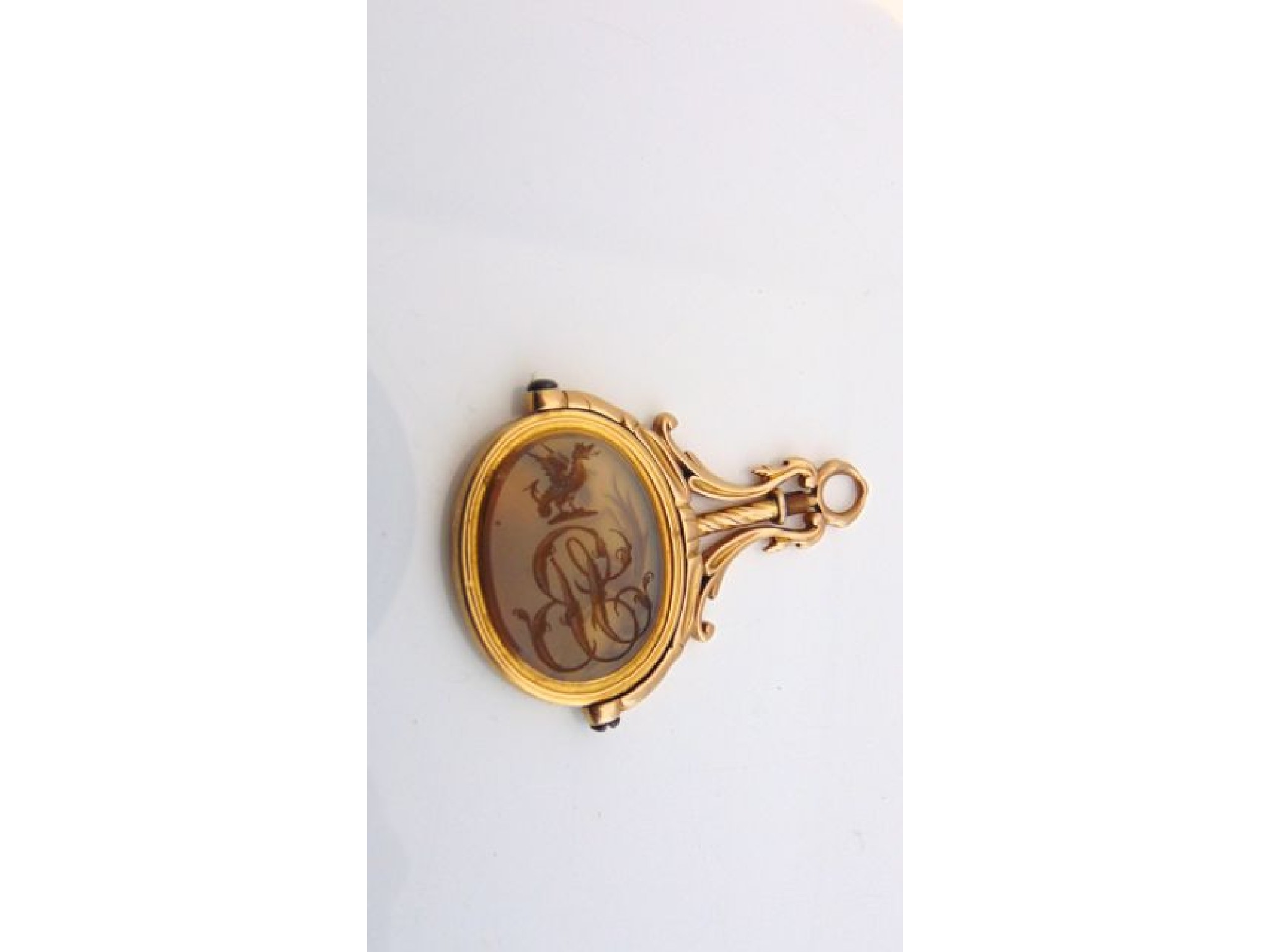 Appraisal: A Georgian swivel fob seal pendant the oval chalcedony intaglio