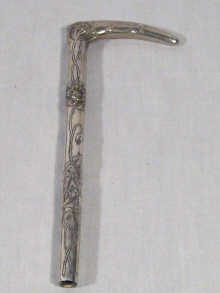 Appraisal: A silver parasol handle with riding crop handle and Art