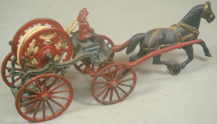 Appraisal: Cast iron toy horse drawn fireman's hose carriage includes removable