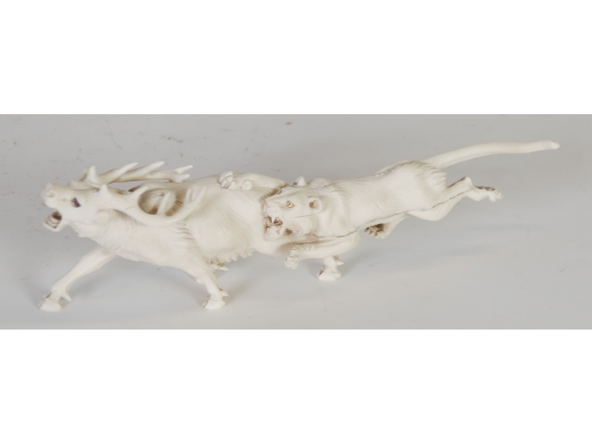 Appraisal: AN ORIENTAL CARVED ONE PIECE IVORY GROUP OF A LIONESS